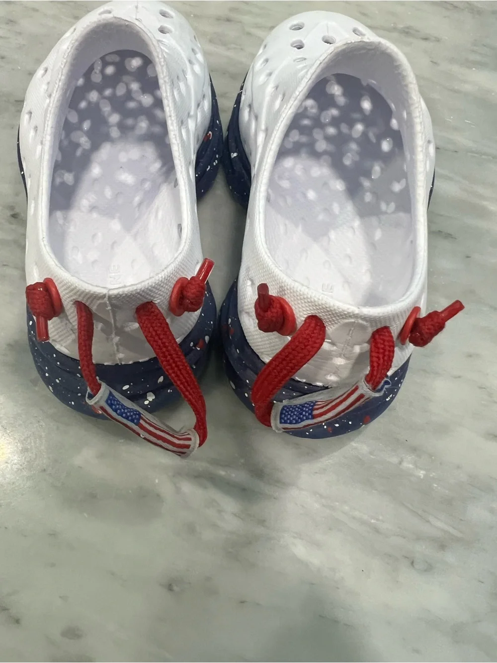 Kids White Slip-On Water Shoes with Navy Speckled Sole and Red Pull Tab